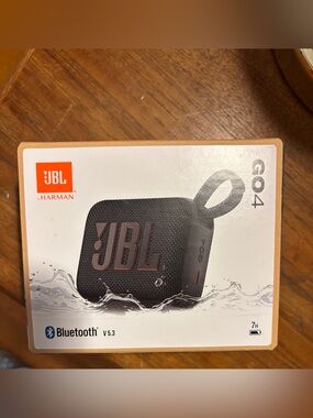JBL GO 4 Portable Bluetooth Speaker — Black with Orange Accents